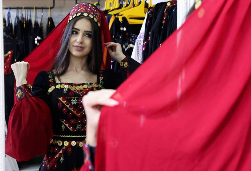 A woman tries on an outfit at the clothes shop.