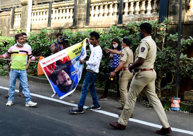People with banners of Bollywood actor Shah Rukh Khan and his son Aryan Khan gather outside Aryan's residence in Mumbai to celebrate his release from jail on bail. All photos: AFP