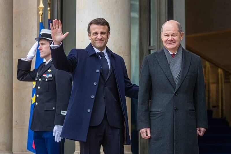 French President Emmanuel Macron, left, welcomes German Chancellor Olaf Scholz to the Elysee Palace in Paris on Sunday. EPA