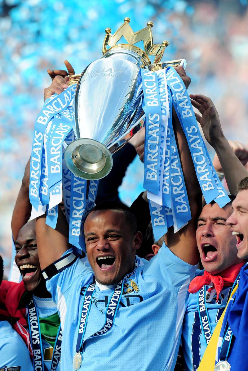 MANCHESTER, ENGLAND - MAY 13:  Vincent Kompany the captain of Manchester City lifts the trophy following the Barclays Premier League match between Manchester City and Queens Park Rangers at the Etihad Stadium on May 13, 2012 in Manchester, England.  (Photo by Shaun Botterill/Getty Images)