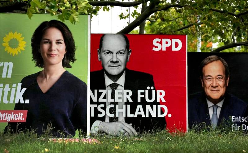 Posters for Annalena Baerbock, Olaf Scholz and Armin Laschet in the final weeks of the German election campaign. AP