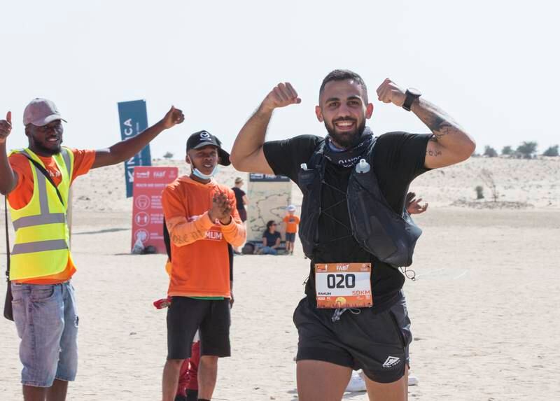 A participant in the 50km race gestures as he arrives at the finish line at Al Marmoom Ultramarathon.