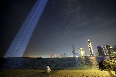 Collider, created by Mexican artist Rafael Lozano-Hemmer using hundreds of pencil-beam robotic searchlights, is viewed from Lulu Island as part of the Manar Abu Dhabi exhibition of light art. AFP
