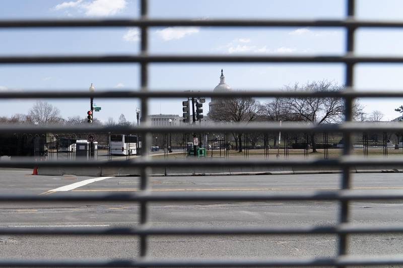 The US Capitol building seen through a mesh security fence. Willy Lowry / The National