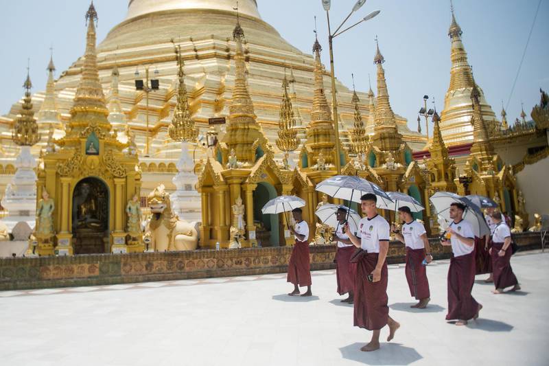 Members of Leeds United wearing traditional Myanmar longyi men's outfit visit Yangon's landmark Buddhist Shwedagon pagoda in Myanmar. Ye Aung Thu / AFP
