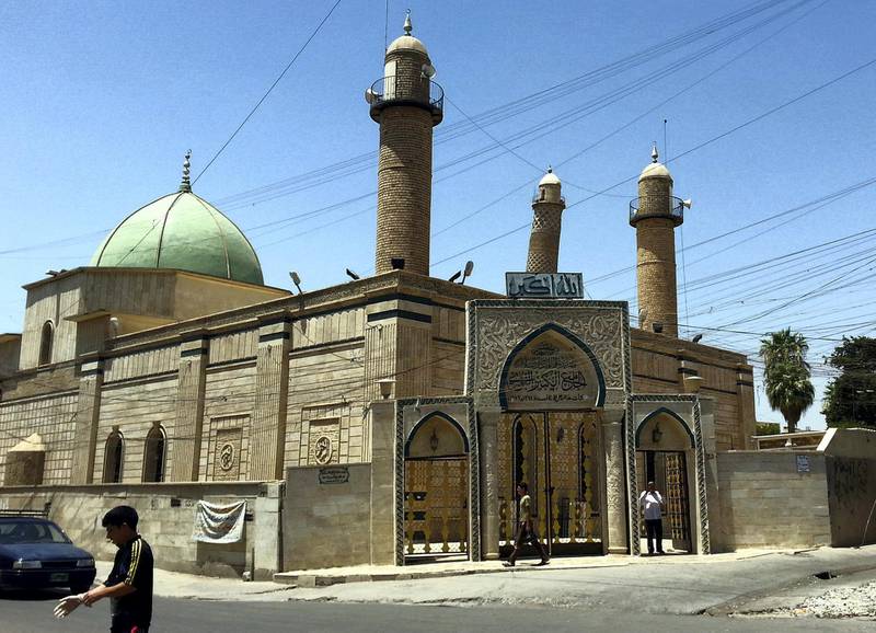 epa06041871 (FILE) - People walk in front of the Al-Noori Al-Kabeer mosque in Mosul, Iraq, 09 July 2014 (reissued 21 June 2017). According to media reports on 21 June 2017 citing Iraq's military, the Great Mosque of al-Nuri and its leaning minaret have been destroyed by members of the Islamic State militant group. Abu Bakr al-Baghdadi, the leader of the Sunni extremist group IS appeared for the first time in public at the mosque to declared caliphate on 04 July 2014.  EPA/STR *** Local Caption *** 53599216
