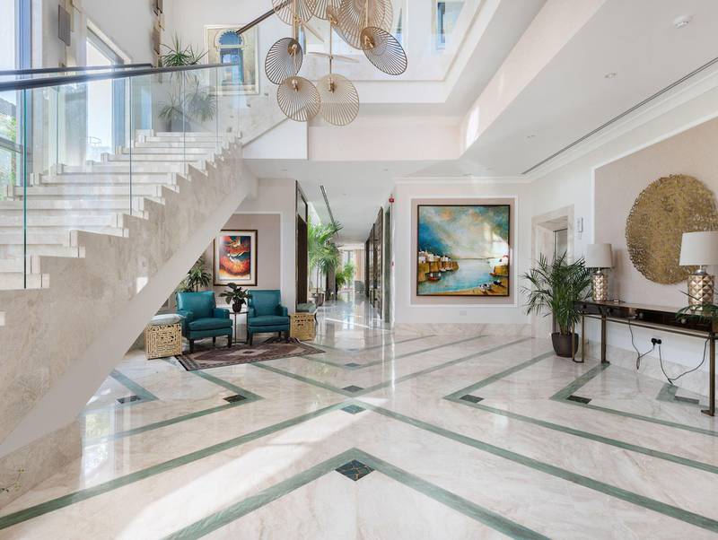 The grand entrance has a triple-height ceiling. Courtesy Luxhabitat Sotheby's International Realty