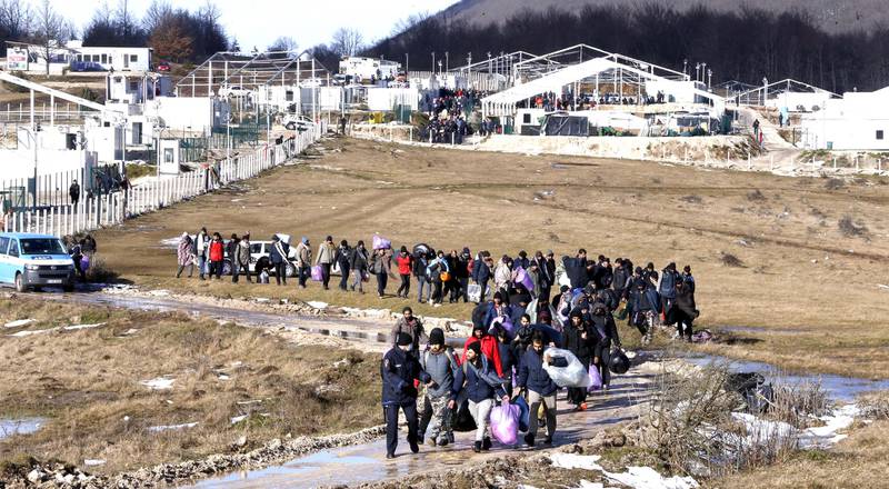 Migrants leave from the burning camp Lipa. A fire destroyed most of the camp near the city of Bihac. EPA