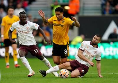 Wolverhampton Wanderers' Joao Gomes, centre, is fouled by Manchester City's Mateo Kovacic. PA