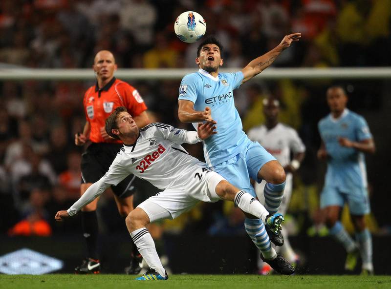 MANCHESTER, ENGLAND - AUGUST 15:  Sergio Aguero of Manchester City holds off a challenge from Joe Allen of Swansea City during the Barclays Premier League match between Manchester City and Swansea City at Etihad Stadium on August 15, 2011 in Manchester, England.  (Photo by Alex Livesey/Getty Images)