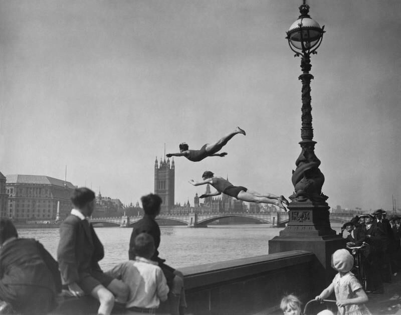 Two divers jump off the Embankment into the River Thames in London, in 1934.