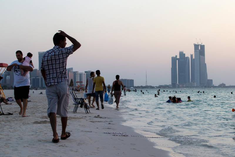 Abu Dhabi, United Arab Emirates, October 11, 2013:     People walk along the corniche on the first day of of Eid Al Adha in Abu Dhabi on October 11, 2013. Christopher Pike / The National

Reporter: N/A
Section: News *** Local Caption ***  CP1011-eid009.JPG