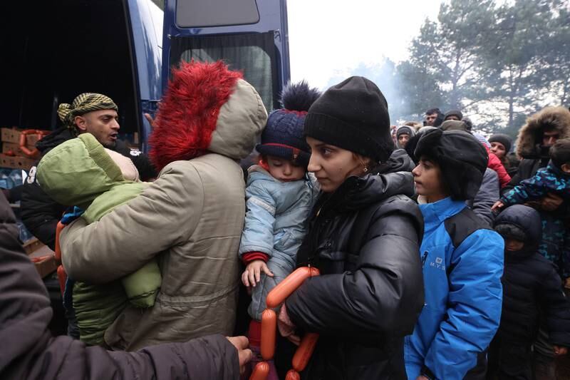 Migrants receive aid from the Belarusian Red Cross and members of the Council of the Belarus Republic. EPA
