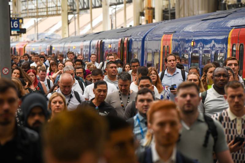 Commuters arrive on one of the limited running services at London Waterloo railway station in London. Bloomberg