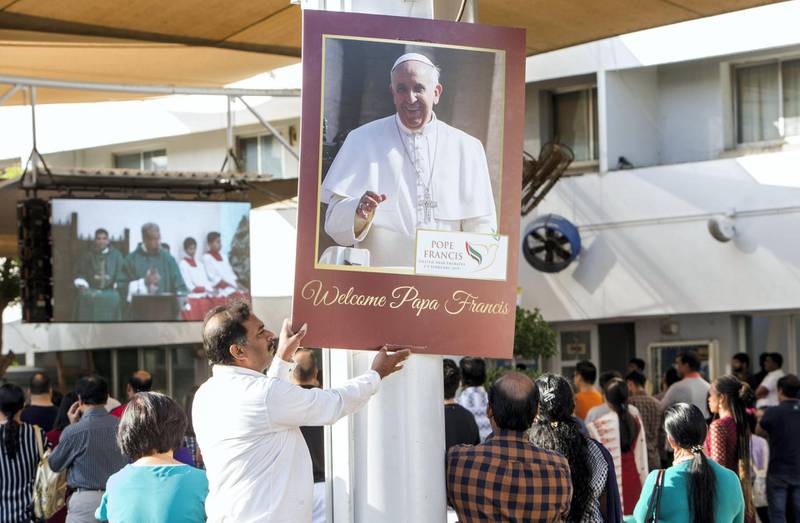 DUBAI, UNITED ARAB EMIRATES -A church volunteer arranging the papal poster at St. Mary's Catholic Church, Oud Mehta.  Leslie Pableo for The National for Anam Rizvi's story