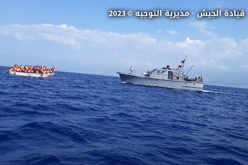 In this photo released by the Lebanese Army official website, a Lebanese vessel approaches a overcrowded boat with migrants in the Mediterranean Sea, near the shores of Tripoli, north Lebanon. Lebanese Army Website via AP