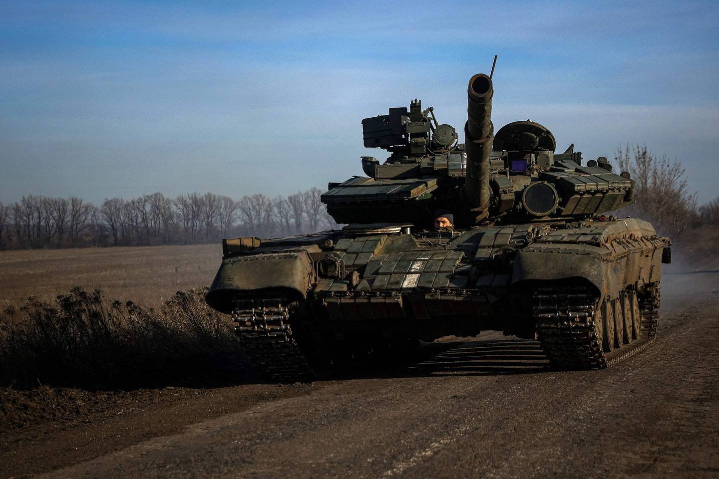 A Ukrainian tank drives down a road near Bakhmut in the Donetsk region.  AFP