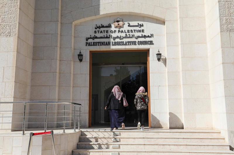 Employees enter the defunct Palestinian Parliament building in the West Bank city of Ramallah. AFP