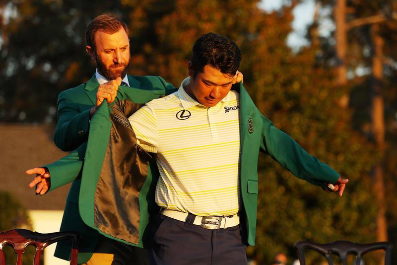 Hideki Matsuyama of Japan is awarded the Green Jacket by 2020 Masters champion Dustin Johnson of the United States during the Green Jacket Ceremony after he won the Masters at Augusta National Golf Club. AFP