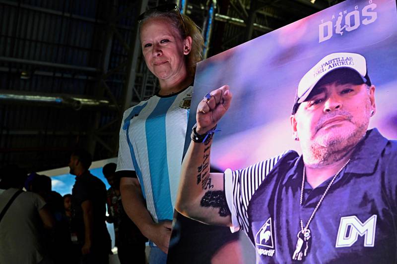 A fan of Argentina's Diego Maradona holds up a poster. AFP