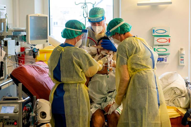 Senior doctor Markus Keim and medical staff colleagues examine a patient on the Covid-19 intensive care unit of the Klinikum Rechts der Isar hospital in Munich, southern Germany. AFP