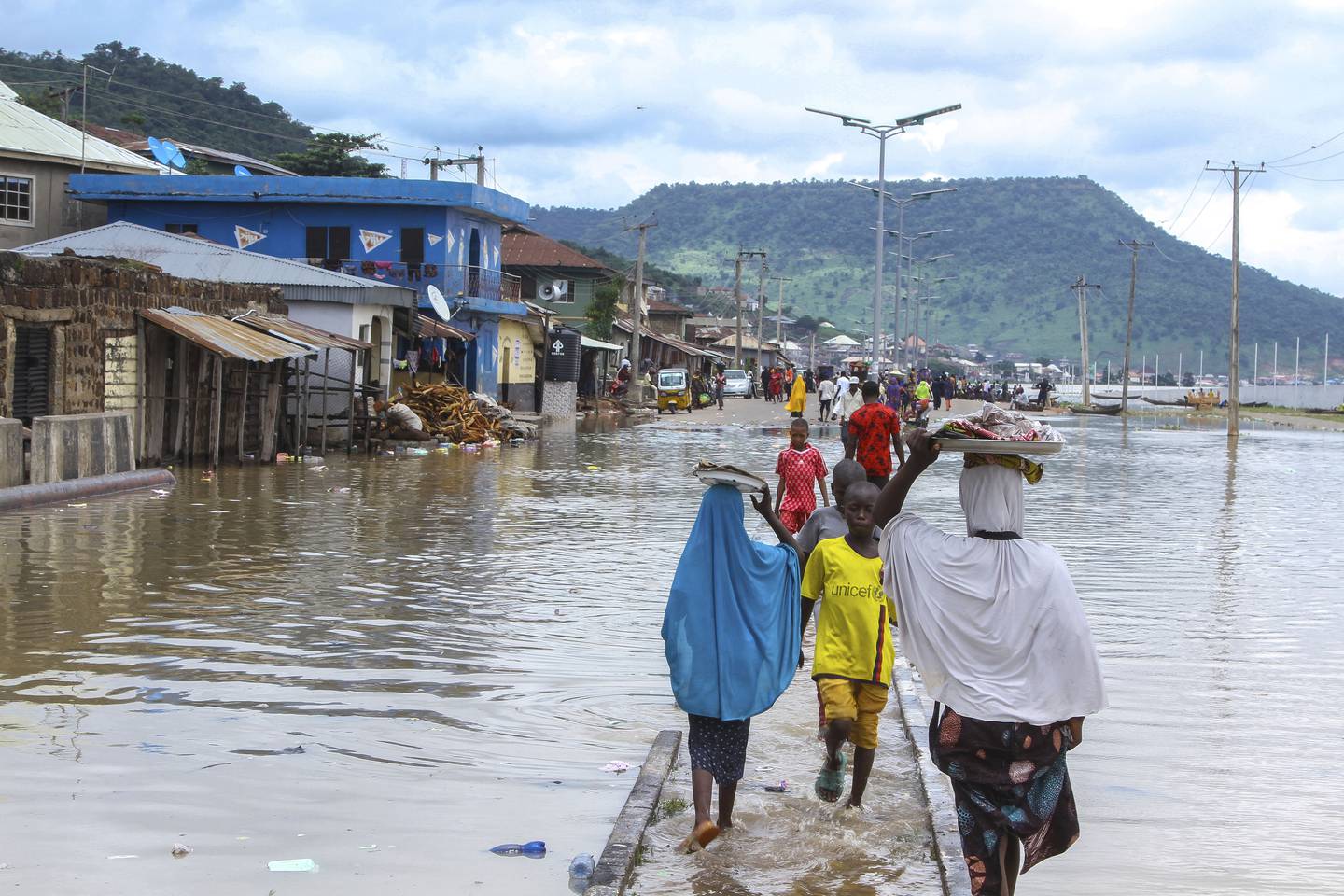 People stranded due to floods following several days of downpours In Kogi Nigeria, on October 6.  Thousands of travelers remained stranded in Nigeria's northcentral Kogi state after major connecting roads to other parts of the West African nation were submerged in floods, locals and authorities said Thursday.  AP