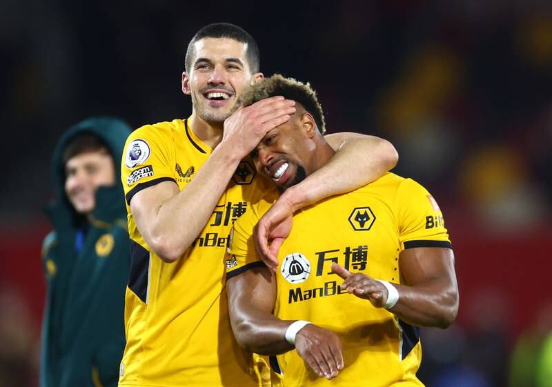 Adama Traore is hugged by Wolves teammate Conor Coady after the Premier League match at Brentford Community Stadium on January 22, 2022. Getty