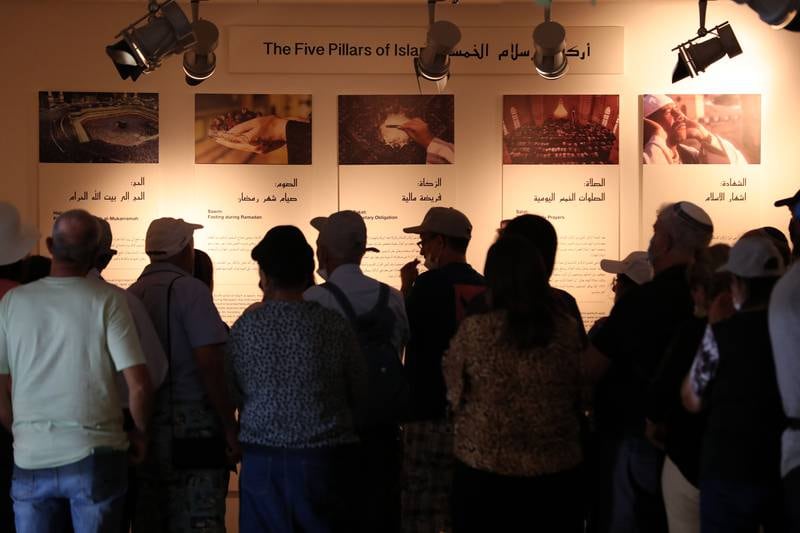 People view an exhibit, 'The Five Pillars of Islam'.