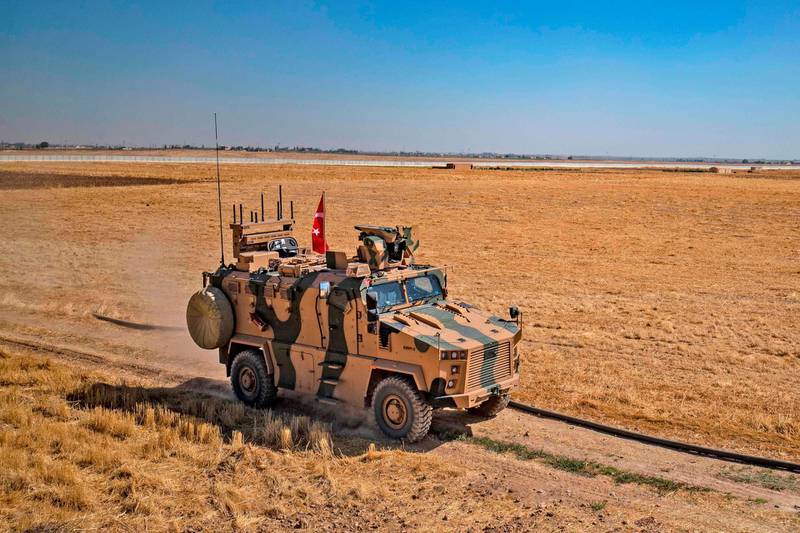 A Turkish military vehicle part of a US military convoy takes part in joint patrol in the Syrian village of al-Hashisha on the outskirts of Tal Abyad town along the border with Turkey, on September 24, 2019. The United States and Turkey began joint patrols in northeastern Syria aimed at easing tensions between Ankara and US-backed Kurdish forces. / AFP / Delil SOULEIMAN
