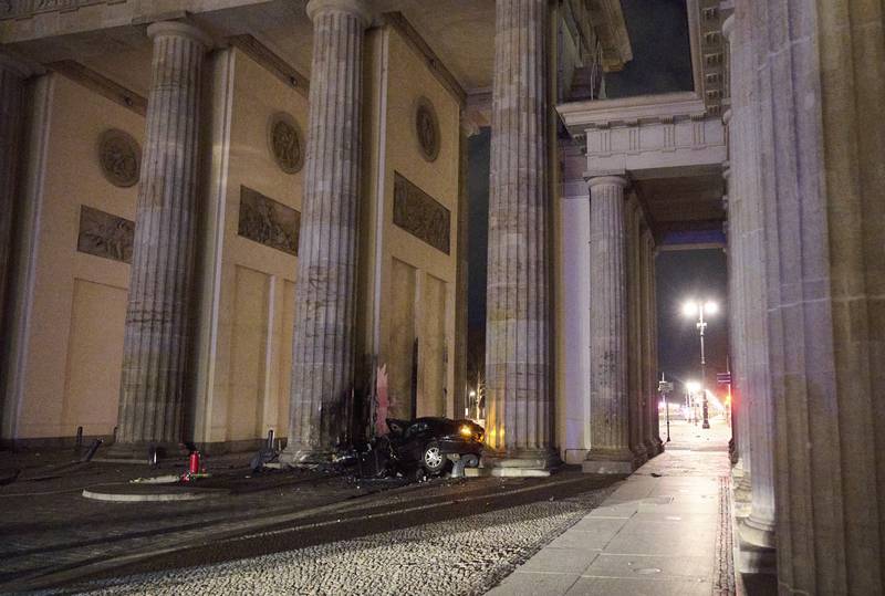 A wrecked car at Brandenburg Gate in Berlin. Firefighters found a dead man in the vehicle, police said. AP