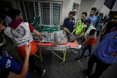 Emergency workers push a stretchered man into Al Shifa Hospital in Gaza city on Monday, after the Israeli army said it carried out more than 500 strikes overnight. EPA