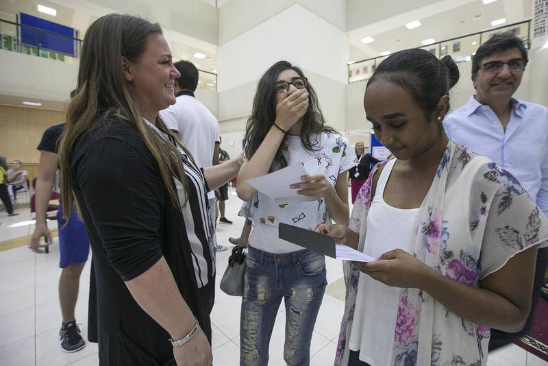Al Yasmina Academy pupils and their families check out the GCSE results. Mona Al Marzooqi / The National