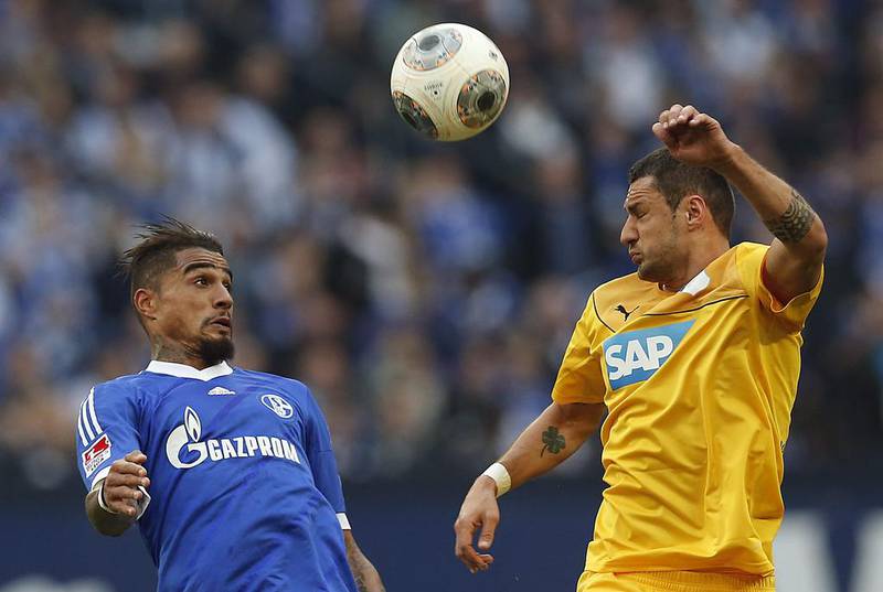 Schalke’s Kevin-Prince Boateng of Ghana, left, and Hoffenheim’s Sejad Salihovic of Bosnia challenge for the ball during the German first division Bundesliga soccer match between Schalke 04 and 1899 Hoffenheim in Gelsenkirchen, Germany, Saturday, March 8, 2014. Frank Augstein / AP Photo