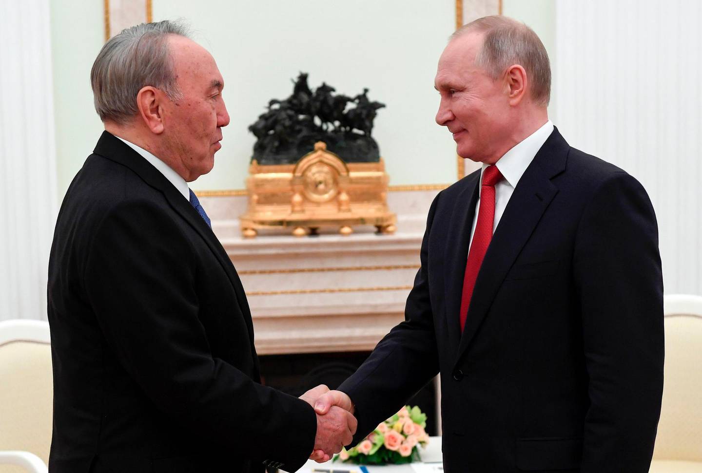 Russian President Vladimir Putin, right, shakes hands with former President of Kazakhstan Nursultan Nazarbayev during their meeting in Kremlin in Moscow, Russia, Tuesday, March 10, 2020. During the meeting, Putin boasted a "strategic alliance" between the two ex-Soviet nations. (Alexei Nikolsky, Sputnik, Kremlin Pool Photo via AP)