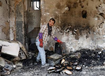 An Afghan man shows burnt iteams of his house after Sunday's attack in Kabul, Afghanistan. REUTERS