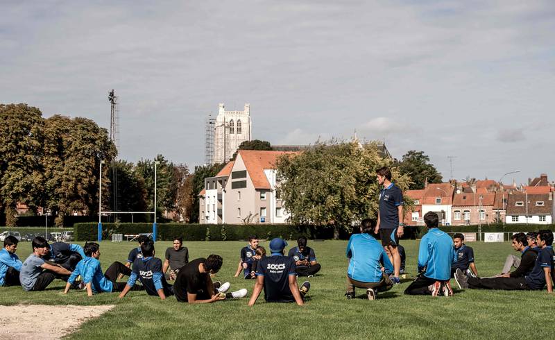 In this photograph taken on September 30, 2017, Afghan and Pakistani migrants gather for a cricket training session in Saint-Omer, northern France.



The image seems surreal, on a rugby field with a cathedral in the background, young Afghan and Pakistani refugees play cricket. In Saint-Omer, in the heart of a region divided on the issue of migrations, a club, starting from scratch and now champion of the Hauts-de-France region , struggles to integrate into the landscape. / AFP PHOTO / PHILIPPE HUGUEN
