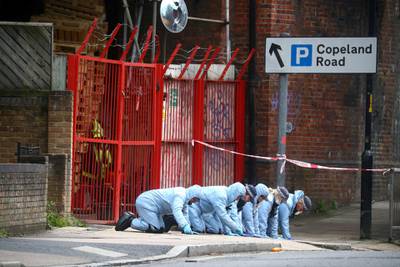 Forensic officers work in the area where Ms Johnson was shot in an early morning attack near her home in Peckham. Reuters