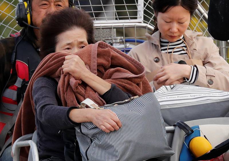 A woman reacts after she was rescued from a flooded area in the aftermath of Typhoon Hagibis, which caused severe floods at the Chikuma River in Nagano Prefecture, Japan. Reuters