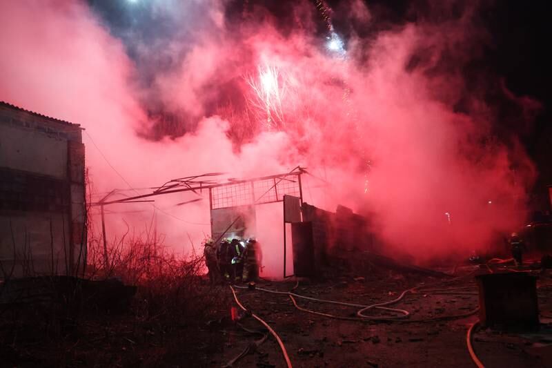 Firefighters work to put out a blaze at a Kharkiv fireworks storage site after it was struck by a Russian missile. Getty