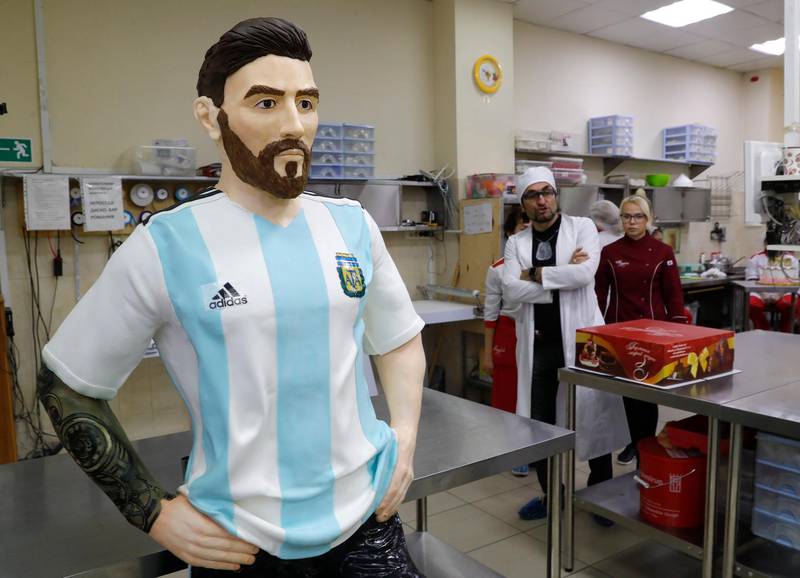 Bakers of Altufyevo Confectionery look on at the life-size chocolate sculpture of Argentine football player Lionel Messi to top a cake for the celebration of his birthday. Reuters