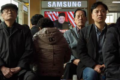 A television screen shows a news broadcast of Kim Jong Un meeting with Donald Trump during their summit in Hanoi, at a railway station in Seoul, South Korea. AFP
