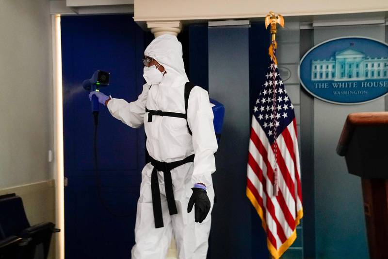 A member of the White House cleaning staff sprays the press briefing room the evening of US President Donald Trump's return from Walter Reed Medical Centre after contracting the coronavirus disease (Covid-19), in Washington, DC, US. Reuters