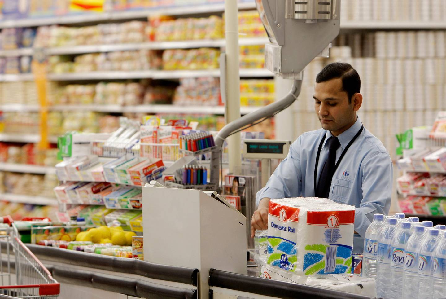 DOHA, QATAR - February 19, 2009: A cashier at Carrefour in the City Centre - Doha, shopping mall.( Ryan Carter / The National )stock, shopping, shop, groceries *** Local Caption ***  RC008-ShoppingQatarB.JPGRC008-ShoppingQatarB.JPG