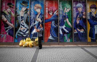 A tourist from abroad takes a photo at Akihabara shopping and amusement district in Tokyo, Japan. Issei Kato / Reuters