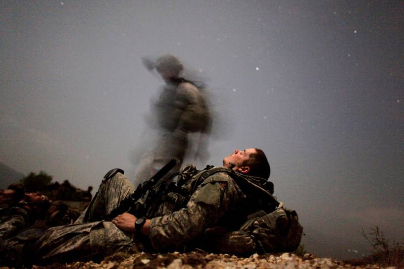 A US soldier of 2-12 Infantry 4BCT-4ID Task Force Mountain Warrior takes a break during a night mission near Honaker Miracle camp at the Pesh valley of Kunar Province, Afghanistan, August 12, 2009. Reuters