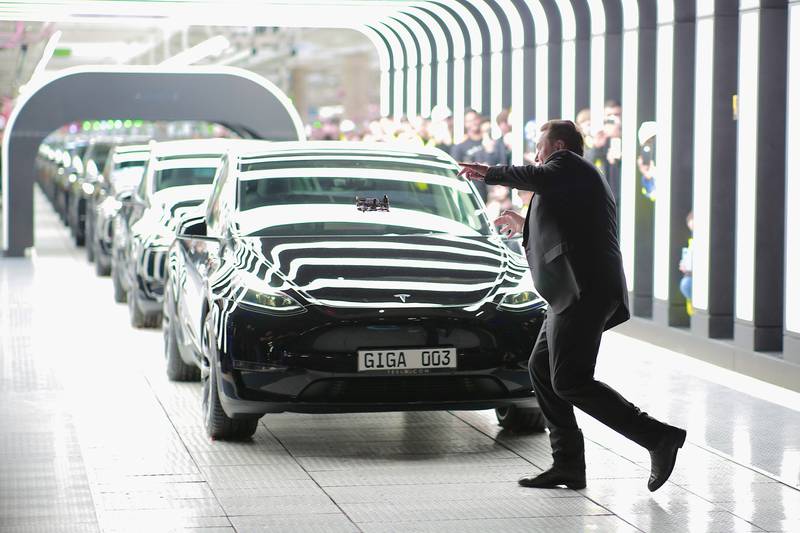 Musk dances as he hands over the first Teslas from the new factory. Getty Images