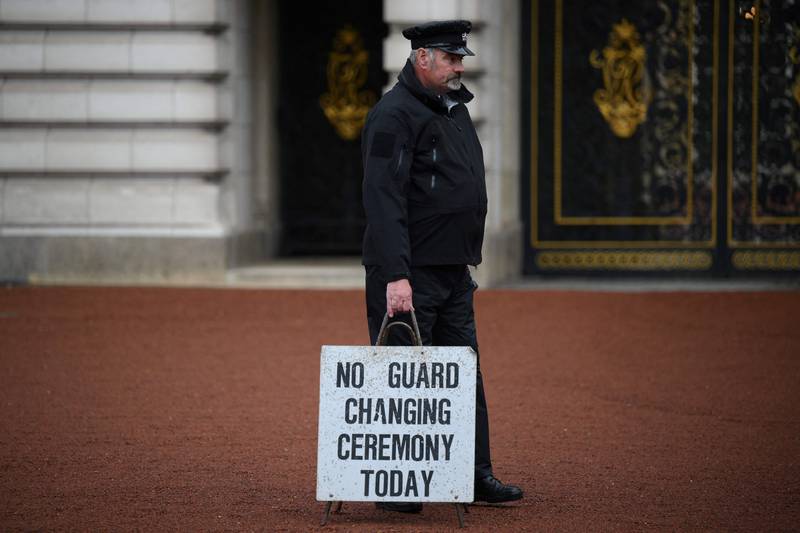 A member of staff crosses the courtyard at Buckingham Palace in London. AFP