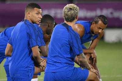 France's forward Kylian Mbappe (L) and France's forward Antoine Griezmann (R) speak together as they attend a training session at the Al Sadd SC training center in Doha, on December 3, 2022, on the eve of the Qatar 2022 World Cup round of 16 football match between France and Poland.  (Photo by FRANCK FIFE  /  AFP)