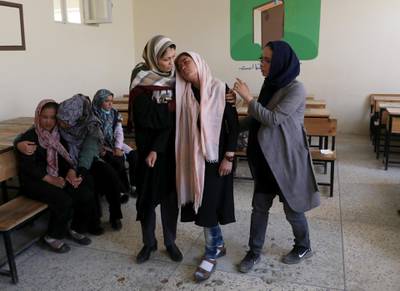 Teachers help a semiconscious schoolgirl during the counselling session. Reuters