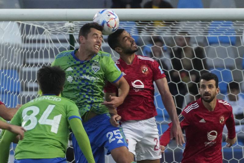 Jackson Ragen of Seattle Sounders challenges for the ball with Al Ahly's Mohamed Abdelmonein. AP